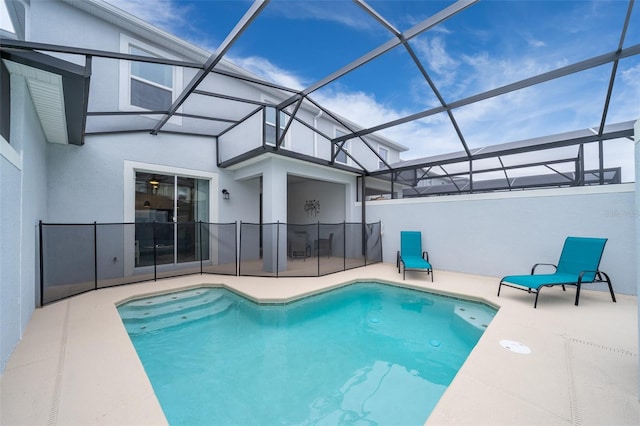 view of pool with a patio and glass enclosure