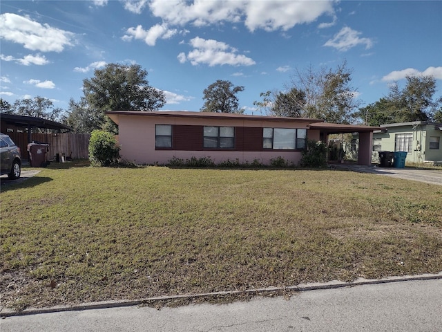 ranch-style house with a front yard and a carport