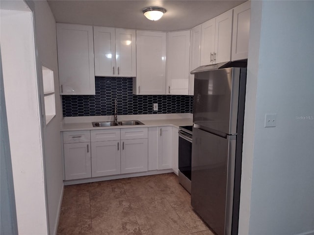 kitchen featuring stainless steel appliances, tasteful backsplash, sink, and white cabinets