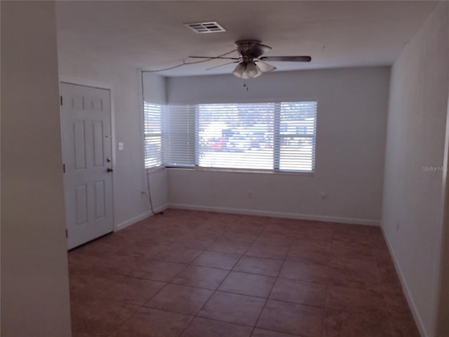 tiled empty room with ceiling fan