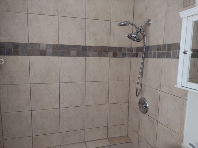 interior details featuring tiled shower