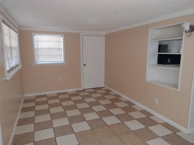 unfurnished room with crown molding