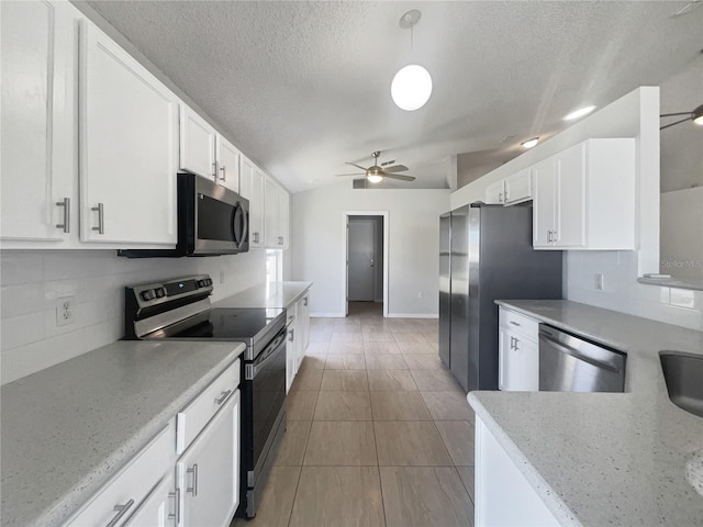 kitchen with white cabinetry, pendant lighting, stainless steel appliances, and ceiling fan