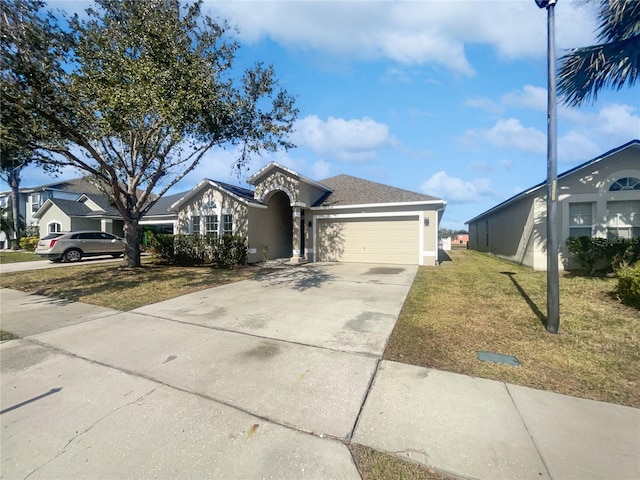 view of front of house featuring a garage and a front lawn