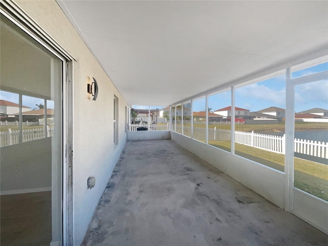 unfurnished sunroom with a water view