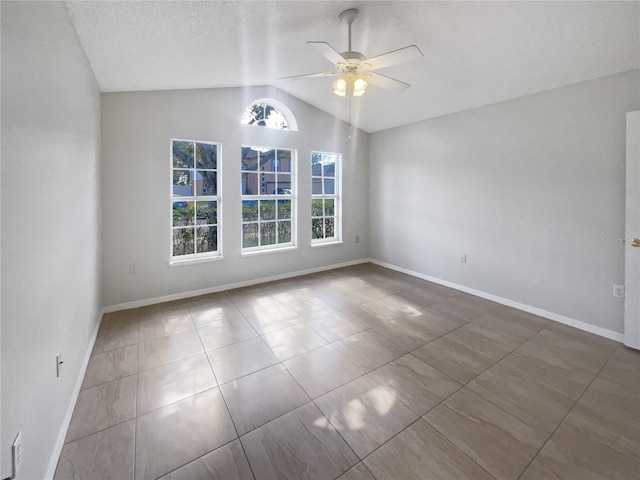 unfurnished room with vaulted ceiling, a textured ceiling, and ceiling fan