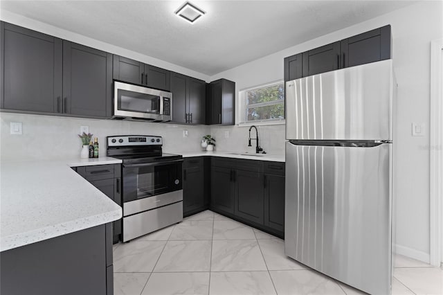 kitchen featuring sink, backsplash, and stainless steel appliances