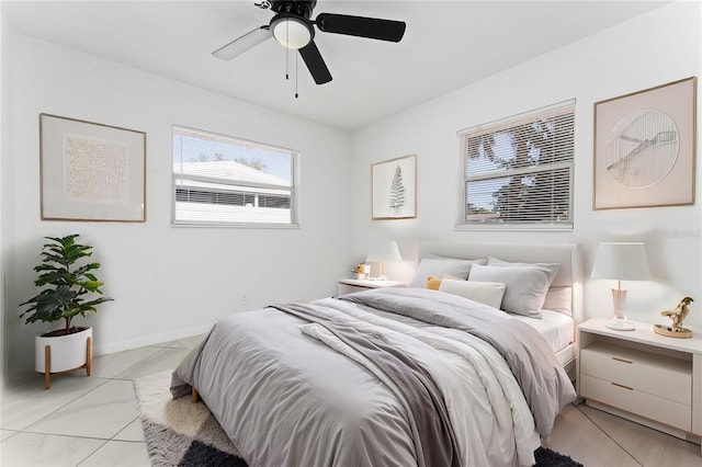 tiled bedroom featuring ceiling fan