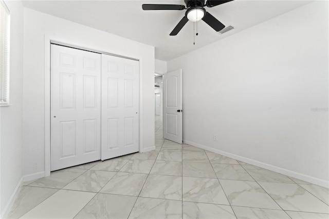 unfurnished bedroom featuring ceiling fan and a closet