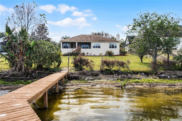 dock area featuring a yard and a water view