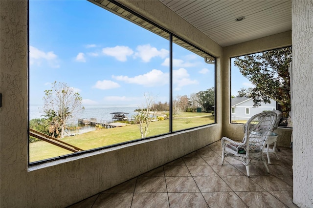 sunroom / solarium with a water view