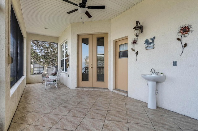 view of patio / terrace featuring french doors, ceiling fan, and sink