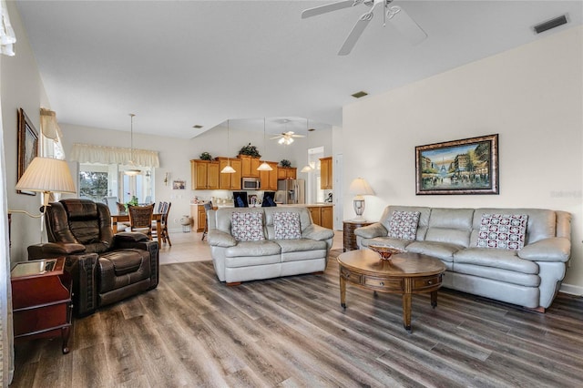 living room featuring dark hardwood / wood-style floors and ceiling fan