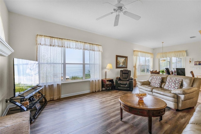 living room with ceiling fan and dark hardwood / wood-style floors