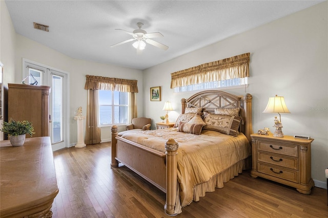 bedroom with ceiling fan, dark hardwood / wood-style floors, and access to exterior