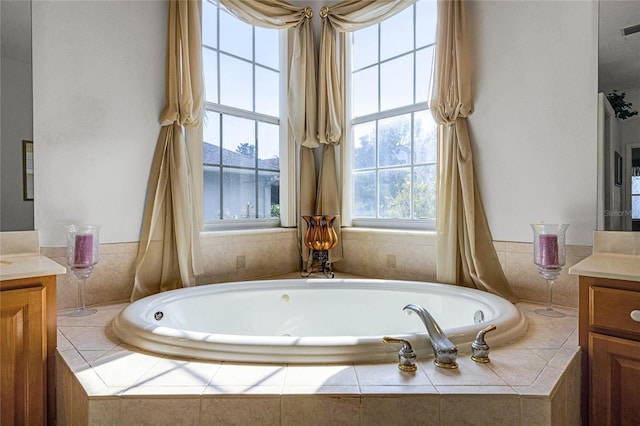 bathroom featuring vanity and tiled tub