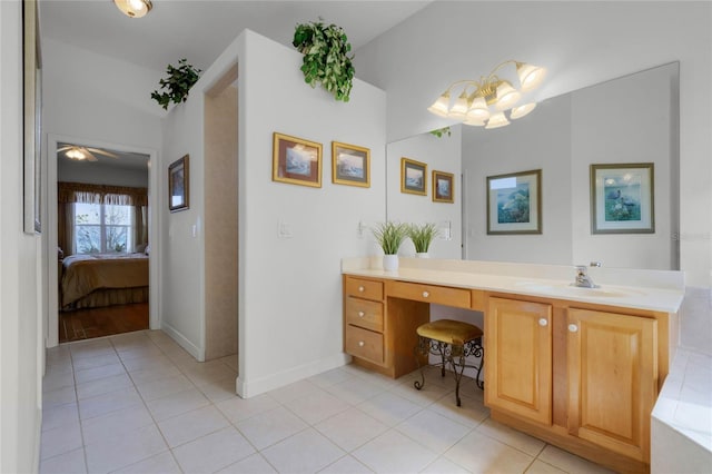 bathroom featuring tile patterned floors, vanity, and a chandelier