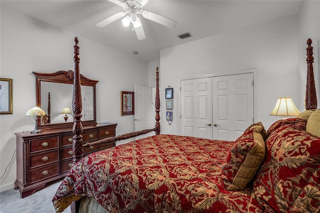 carpeted bedroom with ceiling fan and a closet