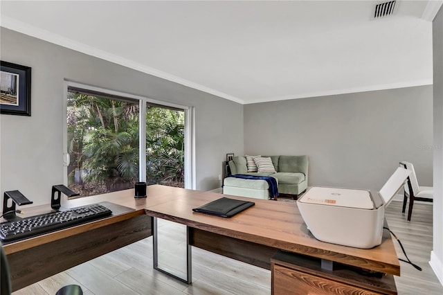 home office featuring ornamental molding and light hardwood / wood-style floors