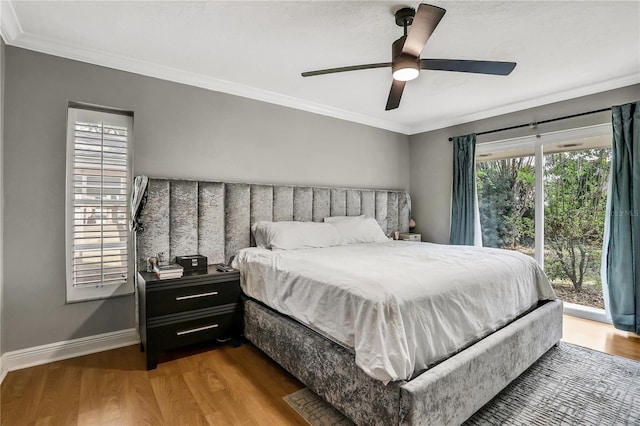 bedroom with hardwood / wood-style floors, crown molding, and ceiling fan