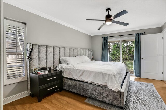 bedroom with wood-type flooring, ornamental molding, ceiling fan, and access to outside