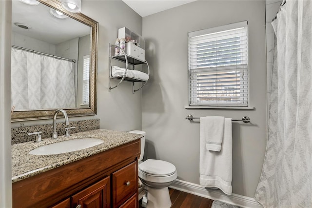 bathroom with hardwood / wood-style flooring, vanity, and toilet