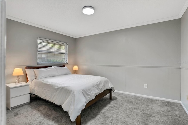 bedroom featuring crown molding and carpet