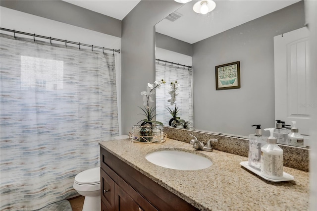 bathroom with vanity and toilet