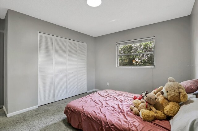 carpeted bedroom featuring a closet