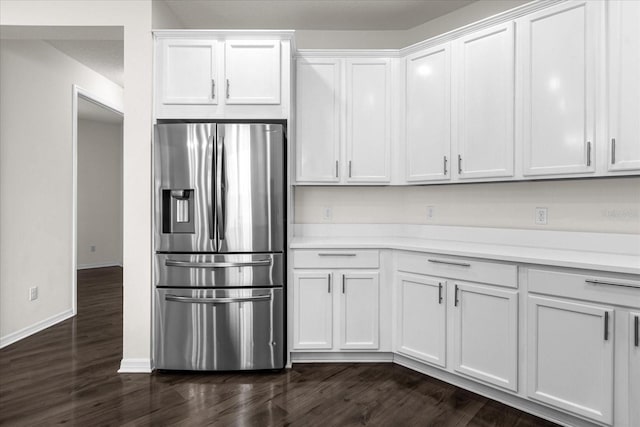 kitchen featuring white cabinetry, dark hardwood / wood-style floors, and stainless steel fridge