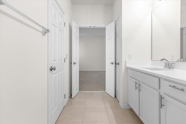 bathroom with tile patterned flooring, vanity, and baseboards