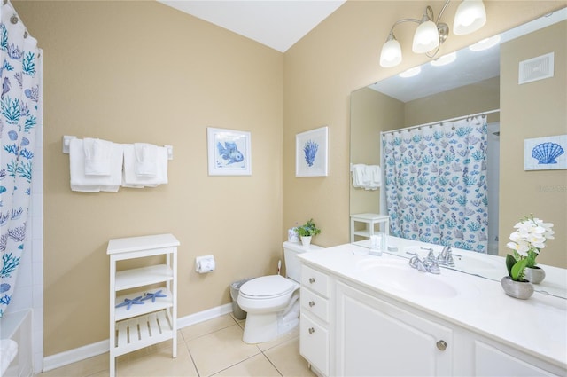 bathroom featuring vanity, tile patterned floors, and toilet