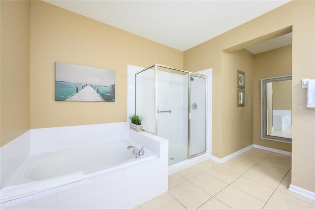 bathroom featuring tile patterned floors and shower with separate bathtub