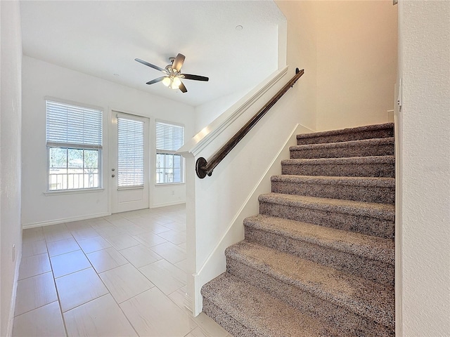 entrance foyer with ceiling fan and light tile patterned floors