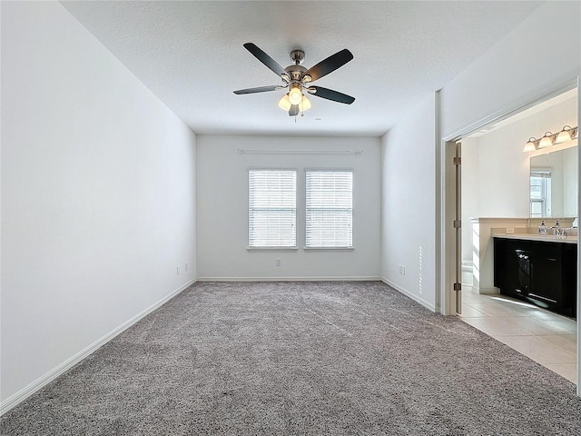 interior space with ceiling fan and a textured ceiling