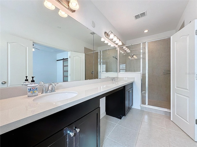 bathroom featuring tile patterned flooring, vanity, and walk in shower