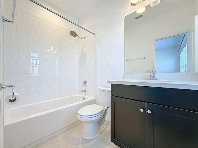 full bathroom with vanity, tiled shower / bath combo, tile patterned floors, and toilet