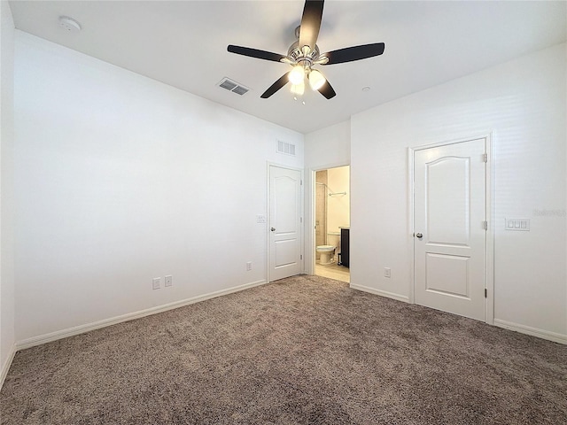 unfurnished bedroom with ensuite bathroom, light carpet, and ceiling fan