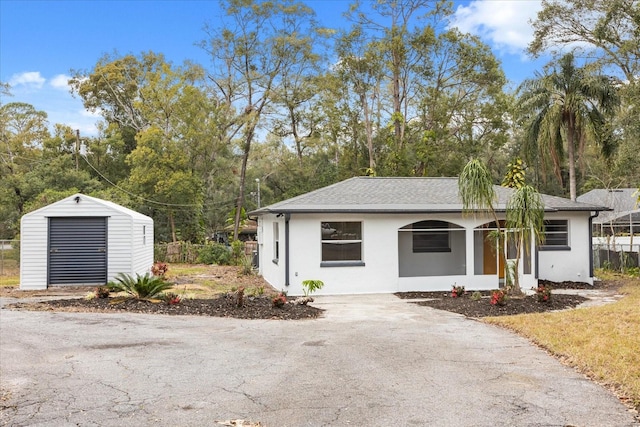 view of front of house featuring a garage and an outdoor structure