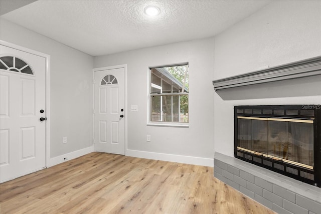 entrance foyer featuring a textured ceiling and light wood-type flooring