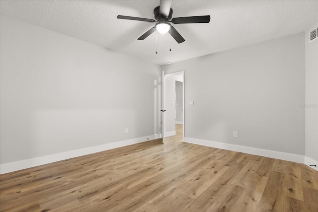 spare room with ceiling fan, a textured ceiling, and light hardwood / wood-style floors