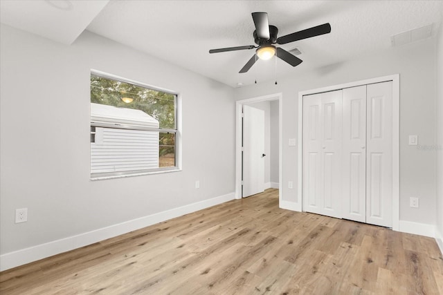 unfurnished bedroom featuring a closet, ceiling fan, and light wood-type flooring