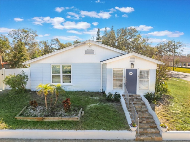 single story home featuring a front yard