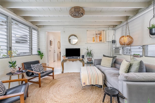 living room featuring cooling unit and beam ceiling