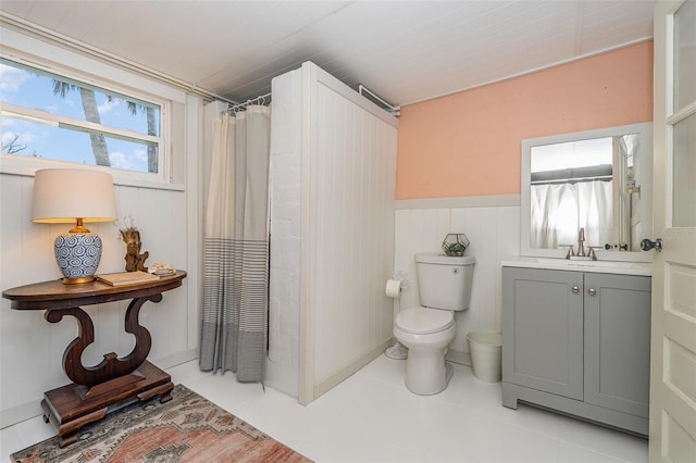 bathroom with walk in shower, vanity, and toilet