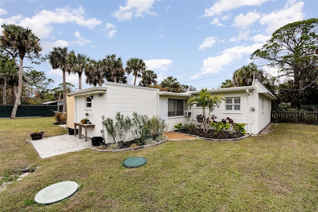 ranch-style house with a patio and a front lawn