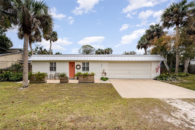 ranch-style home featuring a garage and a front lawn