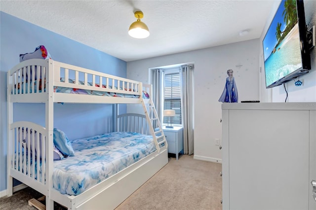 carpeted bedroom featuring a textured ceiling