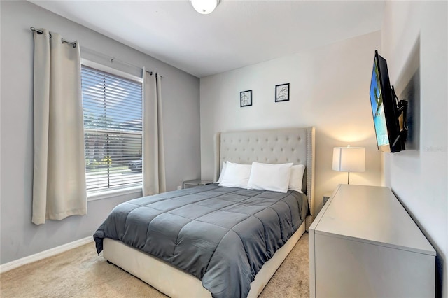 bedroom featuring light carpet