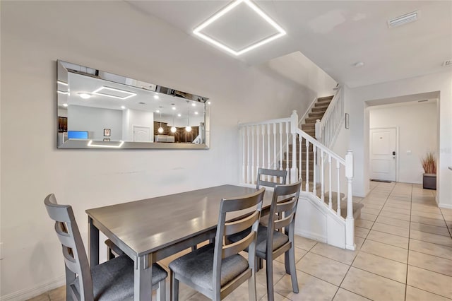 dining space with light tile patterned flooring